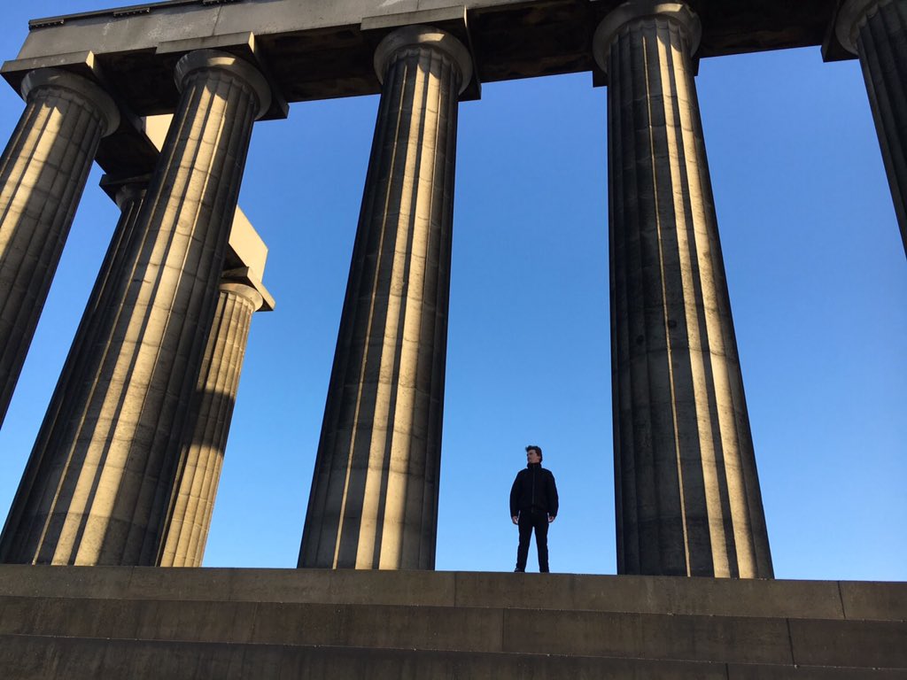 Brad Nicholls in his god stance looking out at Edinburgh